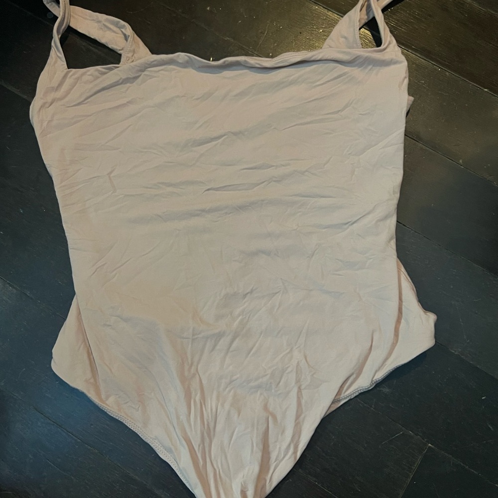 Brownish pink skims low  back thong body suit in size L